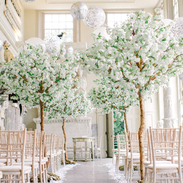 artificial white apple blossom trees set up for a wedding